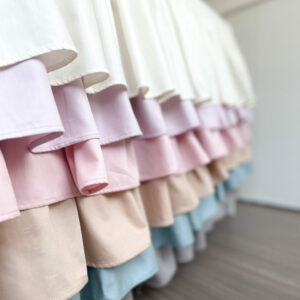 Colorful bed skirts on display on a baby bed